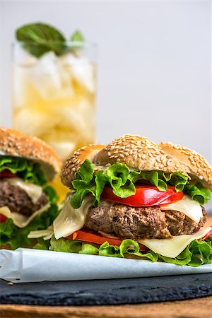 pub burger - Closeup of Homemade Hamburger with Fresh Vegetables and Drink with Ice in Background Stock Photo - Budget Royalty-Free & Subscription, Code: 400-08078150
