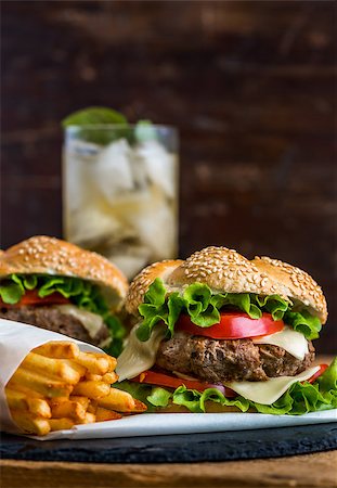 Closeup of Homemade Hamburger with Fresh Vegetables and Drink with Ice in Background Stock Photo - Budget Royalty-Free & Subscription, Code: 400-08078172