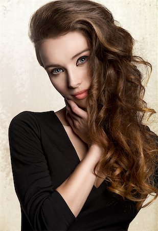 simsearch:400-06790945,k - close-up portrait of very pretty young woman with nice make-up and long volume wavy hair. Wearing black  dress Photographie de stock - Aubaine LD & Abonnement, Code: 400-08078173