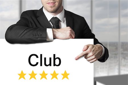 businessman in black suit pointing on white sign club golden stars Foto de stock - Super Valor sin royalties y Suscripción, Código: 400-08070189