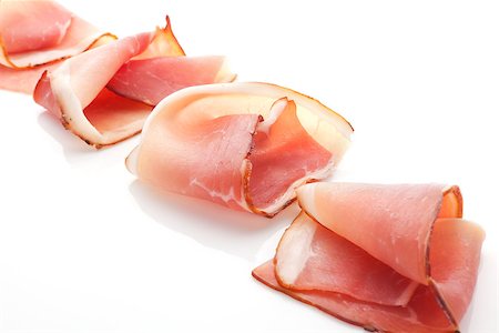 simsearch:400-08071181,k - Prosciutto slices arranged isolated on white background. Culinary traditional meat. Foto de stock - Super Valor sin royalties y Suscripción, Código: 400-08070579