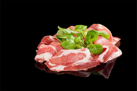 simsearch:400-08070576,k - Proscuitto slices isolated on black background with lamb's lettuce. Culinary ham still life. Foto de stock - Super Valor sin royalties y Suscripción, Código: 400-08071180