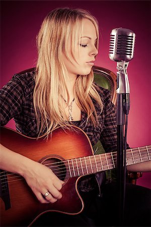 Photo of a beautiful blond woman playing an acoustic guitar. Filtered to have a vintage look. Stock Photo - Budget Royalty-Free & Subscription, Code: 400-08071414