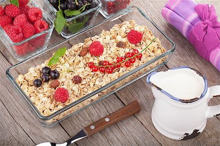 porridge and berries - Healthy breakfast with muesli, milk and berries. On wooden table Stock Photo - Budget Royalty-Free & Subscription, Code: 400-08071452