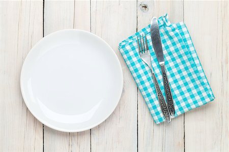 Empty plate, silverware and towel over wooden table background. View from above with copy space Stock Photo - Budget Royalty-Free & Subscription, Code: 400-08071496