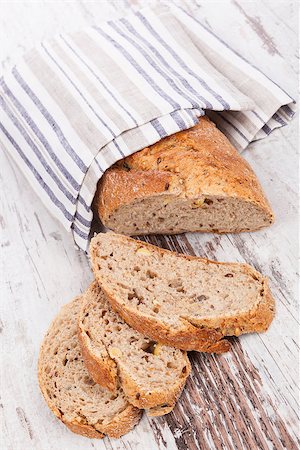 Luxurious delicious whole grain bread on white wooden textured background. Culinary healthy bread eating. Stock Photo - Budget Royalty-Free & Subscription, Code: 400-08072029