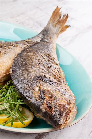 simsearch:400-07776969,k - Grilled sea bream fish on plate with fresh rosemary and lemon. Culinary healthy seafood eating. Foto de stock - Super Valor sin royalties y Suscripción, Código: 400-08072043