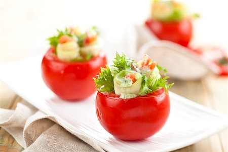 snacks and salads recipes - Closeup shot  of raw  tomatoes stuffed with cucumbers, cream cheese and lettuce. Stock Photo - Budget Royalty-Free & Subscription, Code: 400-08072220