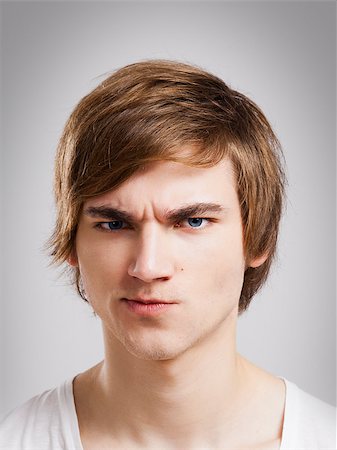 Portrait of a handsome young man, over a gray background Photographie de stock - Aubaine LD & Abonnement, Code: 400-08072490