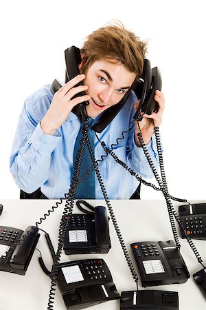 simsearch:400-05710310,k - Young man in the office and answering several phones at the same time Stock Photo - Budget Royalty-Free & Subscription, Code: 400-08072514
