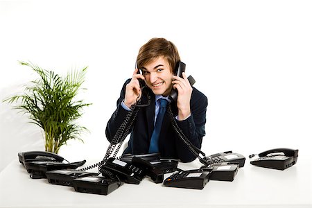 simsearch:400-05710310,k - Businessman sitting with a bunch telephones on his front Stock Photo - Budget Royalty-Free & Subscription, Code: 400-08072513
