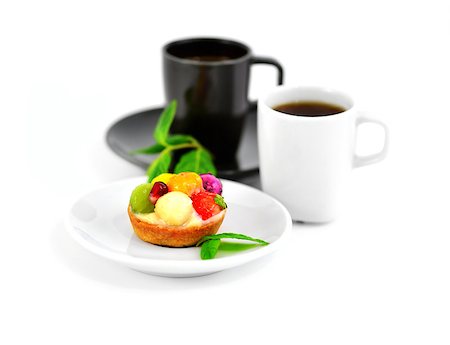 strawberry tartlet - Small fruit cake and two cups of coffee on a blurry background. Stock Photo - Budget Royalty-Free & Subscription, Code: 400-08072551