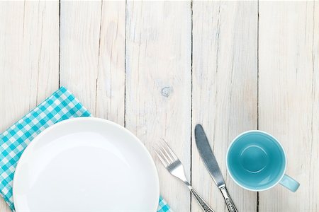 Empty plate, cup and silverware over white wooden table background. View from above with copy space Stock Photo - Budget Royalty-Free & Subscription, Code: 400-08072768