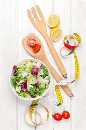 simsearch:400-06485512,k - Fresh healthy salad, utensils and tape measure over white wooden table. View from above Stock Photo - Budget Royalty-Free & Subscription, Code: 400-08072776