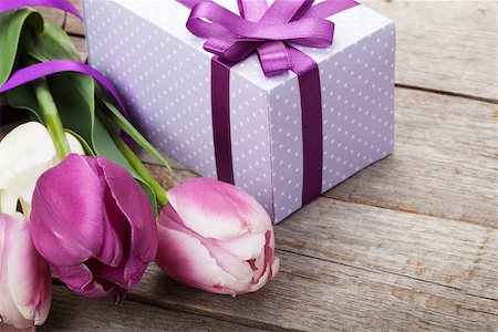 Fresh tulips bouquet and gift box on wooden table with copy space Stock Photo - Budget Royalty-Free & Subscription, Code: 400-08072793