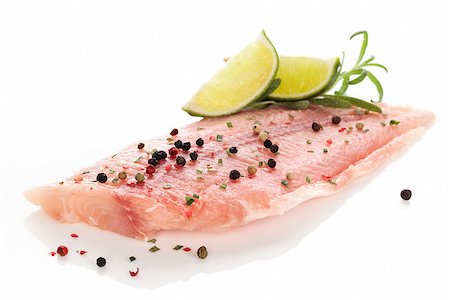 simsearch:400-08070549,k - Delicious raw fish fillet with colorful peppercorn, lemon and fresh rosemary isolated on white. Culinary fish eating. Stockbilder - Microstock & Abonnement, Bildnummer: 400-08072867