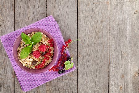 porridge and berries - Healty breakfast with muesli and berries. On wooden table with copy space Stock Photo - Budget Royalty-Free & Subscription, Code: 400-08072954