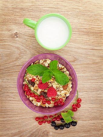 porridge and berries - Healthy breakfast with muesli and milk. View from above on wooden table Stock Photo - Budget Royalty-Free & Subscription, Code: 400-08072955