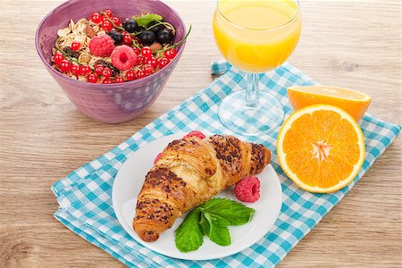 porridge and berries - Healthy breakfast with muesli, berries, orange juice and croissant. On wooden table Stock Photo - Budget Royalty-Free & Subscription, Code: 400-08072956