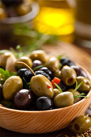 simsearch:400-07219392,k - Close-up shot of marinated olives with herbs and spices in wooden plate. Stock Photo - Budget Royalty-Free & Subscription, Code: 400-08073112