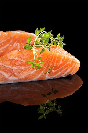 simsearch:400-08070549,k - Salmon steak isolated with fresh herbs isolated on black background. Luxurious seafood eating. Stockbilder - Microstock & Abonnement, Bildnummer: 400-08073377