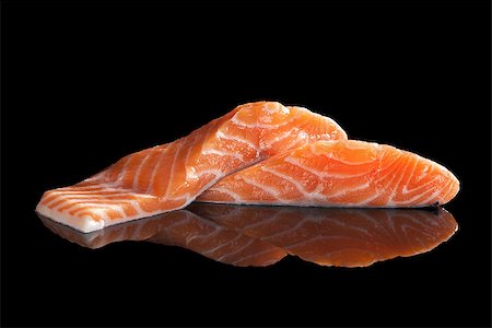 simsearch:400-08070549,k - Sashimi sushi. Fresh raw salmon pieces isolated on black background. Traditional sushi eating. Stockbilder - Microstock & Abonnement, Bildnummer: 400-08073727