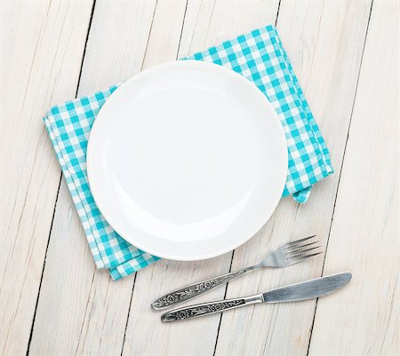 Empty plate, silverware and towel over wooden table background. View from above with copy space Stock Photo - Budget Royalty-Free & Subscription, Code: 400-08073820