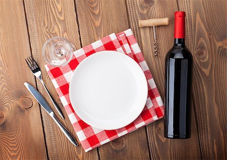 simsearch:400-07933837,k - Table setting with empty plate, wine glass and red wine bottle. View from above over rustic wooden table background Stockbilder - Microstock & Abonnement, Bildnummer: 400-08073848