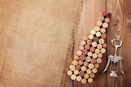 stopper - Wine bottle shaped corks and corkscrew over rustic wooden table background and burlap. Top view with copy space Stock Photo - Budget Royalty-Free & Subscription, Code: 400-08073843