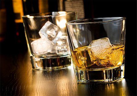 whiskey glass with ice in front of empty whiskey glass on wood table Stock Photo - Budget Royalty-Free & Subscription, Code: 400-08094047