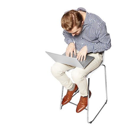 simsearch:400-07514126,k - Young man leaning over the keyboard. Isolated on white background. Fotografie stock - Microstock e Abbonamento, Codice: 400-08094189