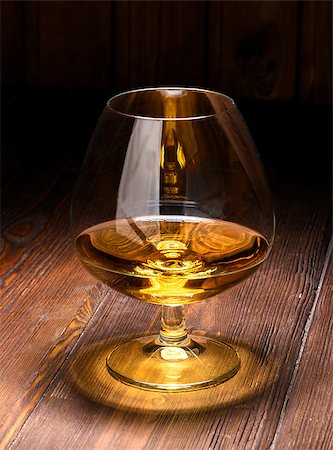 Luxury still life with glass of cognac, on a wood background. Front view with copyspace. Close up shot. High resolution Photographie de stock - Aubaine LD & Abonnement, Code: 400-08095700