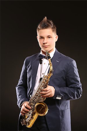 simsearch:400-06134635,k - Photo of a teenager and his saxophone. Professional musician preparing for concert. Stock Photo - Budget Royalty-Free & Subscription, Code: 400-08098564