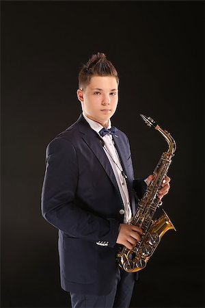 simsearch:400-06134635,k - Photo of a teenager and his saxophone. Professional musician preparing for concert. Stock Photo - Budget Royalty-Free & Subscription, Code: 400-08098565