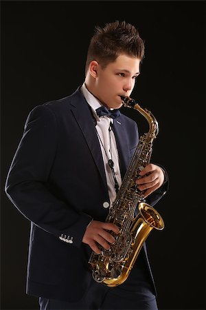 pictures of a man playing saxophone - Photo of a teenager and his saxophone. Professional musician preparing for concert. Stock Photo - Budget Royalty-Free & Subscription, Code: 400-08098566