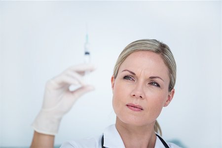 doctor preparing shot - Doctor preparing syringe in medical office Stock Photo - Budget Royalty-Free & Subscription, Code: 400-08098856