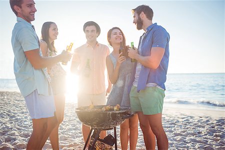 Happy friends doing barbecue and drinking beer at the beach Stock Photo - Budget Royalty-Free & Subscription, Code: 400-08099468