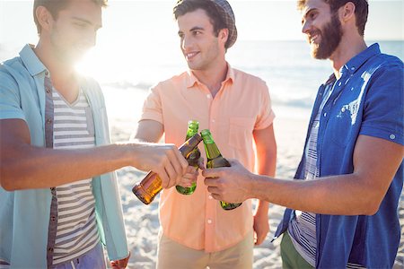 Handsome men toasting at the beach Stock Photo - Budget Royalty-Free & Subscription, Code: 400-08099462