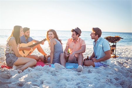 Happy hipsters relaxing and playing guitar at the beach Photographie de stock - Aubaine LD & Abonnement, Code: 400-08099471