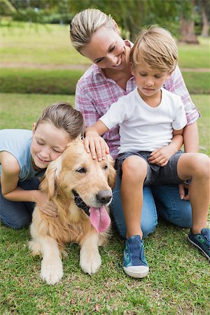 family dog lifestyle - Happy family in the park with their dog on a sunny day Foto de stock - Super Valor sin royalties y Suscripción, Código: 400-08099553