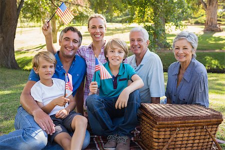 rural american and family - Happy family in the park and holding american flag on a sunny day Stock Photo - Budget Royalty-Free & Subscription, Code: 400-08099567