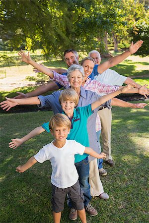Happy family with arms outstretched in the park on a sunny day Stock Photo - Budget Royalty-Free & Subscription, Code: 400-08099581