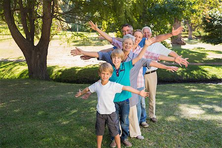 Happy family with arms outstretched in the park on a sunny day Stock Photo - Budget Royalty-Free & Subscription, Code: 400-08099582