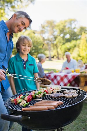 father child son grill - Happy father doing barbecue with his son on a sunny day Stock Photo - Budget Royalty-Free & Subscription, Code: 400-08099622