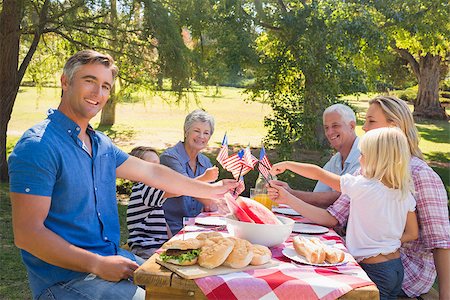 rural american and family - Happy family having picnic and holding american flag on a sunny day Stock Photo - Budget Royalty-Free & Subscription, Code: 400-08099650