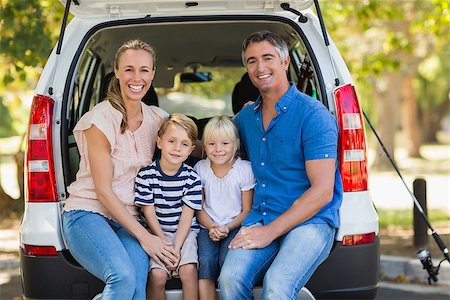 Portrait of a happy family of four sitting in car trunk while on picnic Stock Photo - Budget Royalty-Free & Subscription, Code: 400-08099698