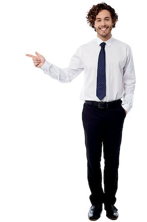 Handsome corporate guy pointing at something Stock Photo - Budget Royalty-Free & Subscription, Code: 400-08107884