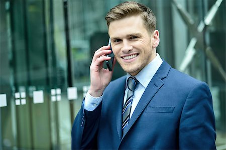 simsearch:400-08750050,k - Successful businessman on the phone outside office building Stock Photo - Budget Royalty-Free & Subscription, Code: 400-08108411