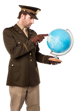 Young military officer holding globe map and indicating Stock Photo - Budget Royalty-Free & Subscription, Code: 400-08109049