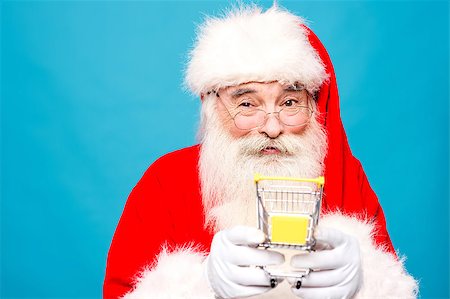 simsearch:400-05711921,k - Happy santa claus holding shopping cart Stock Photo - Budget Royalty-Free & Subscription, Code: 400-08109274